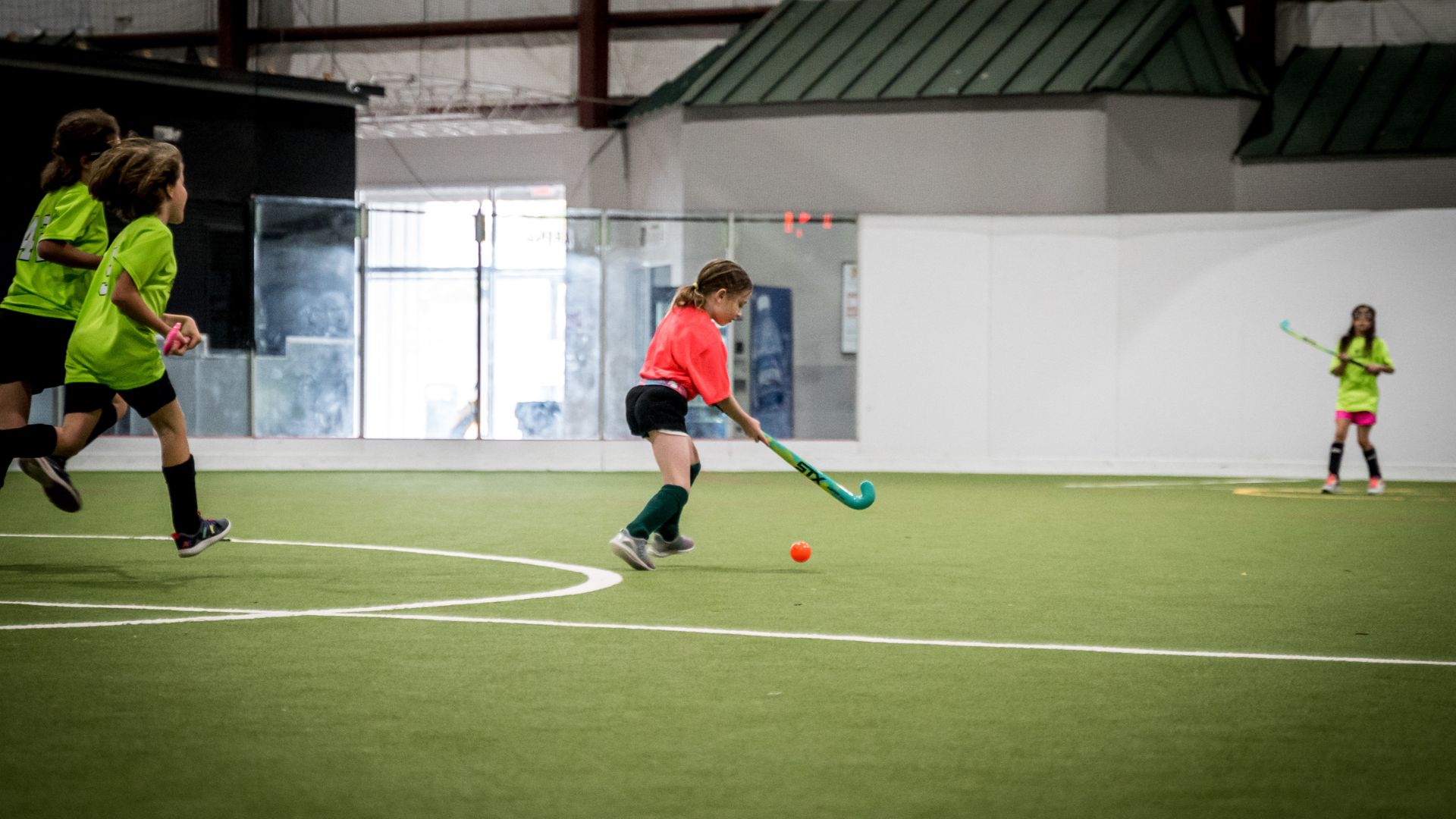Young child playing field hockey