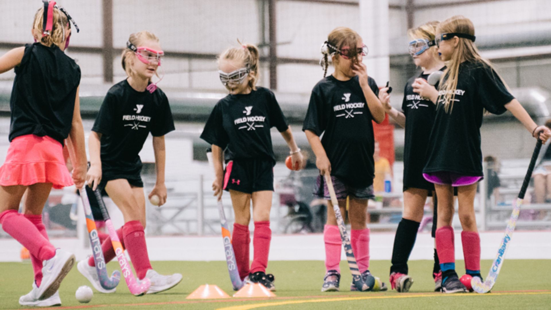 Kids learning how to play field hockey