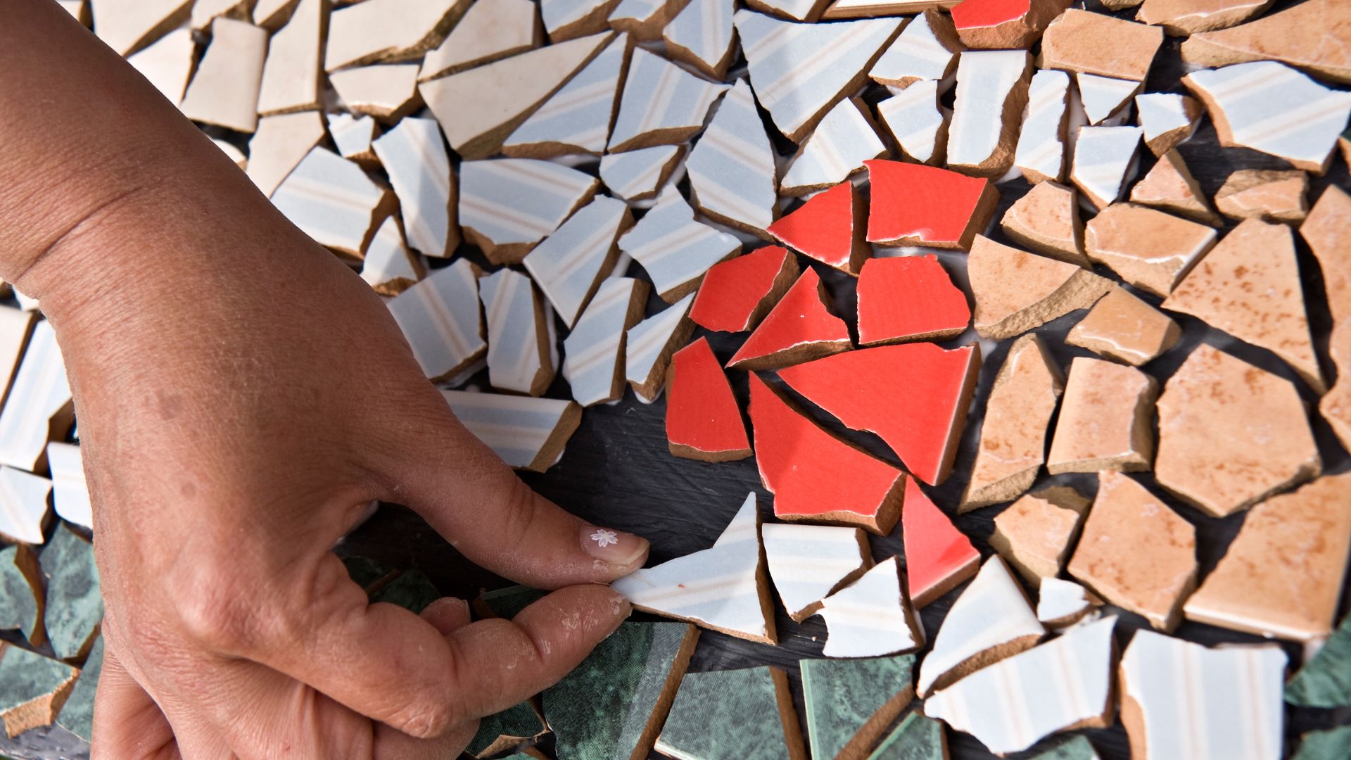 Person creating a mosaic Person creating a mosaic