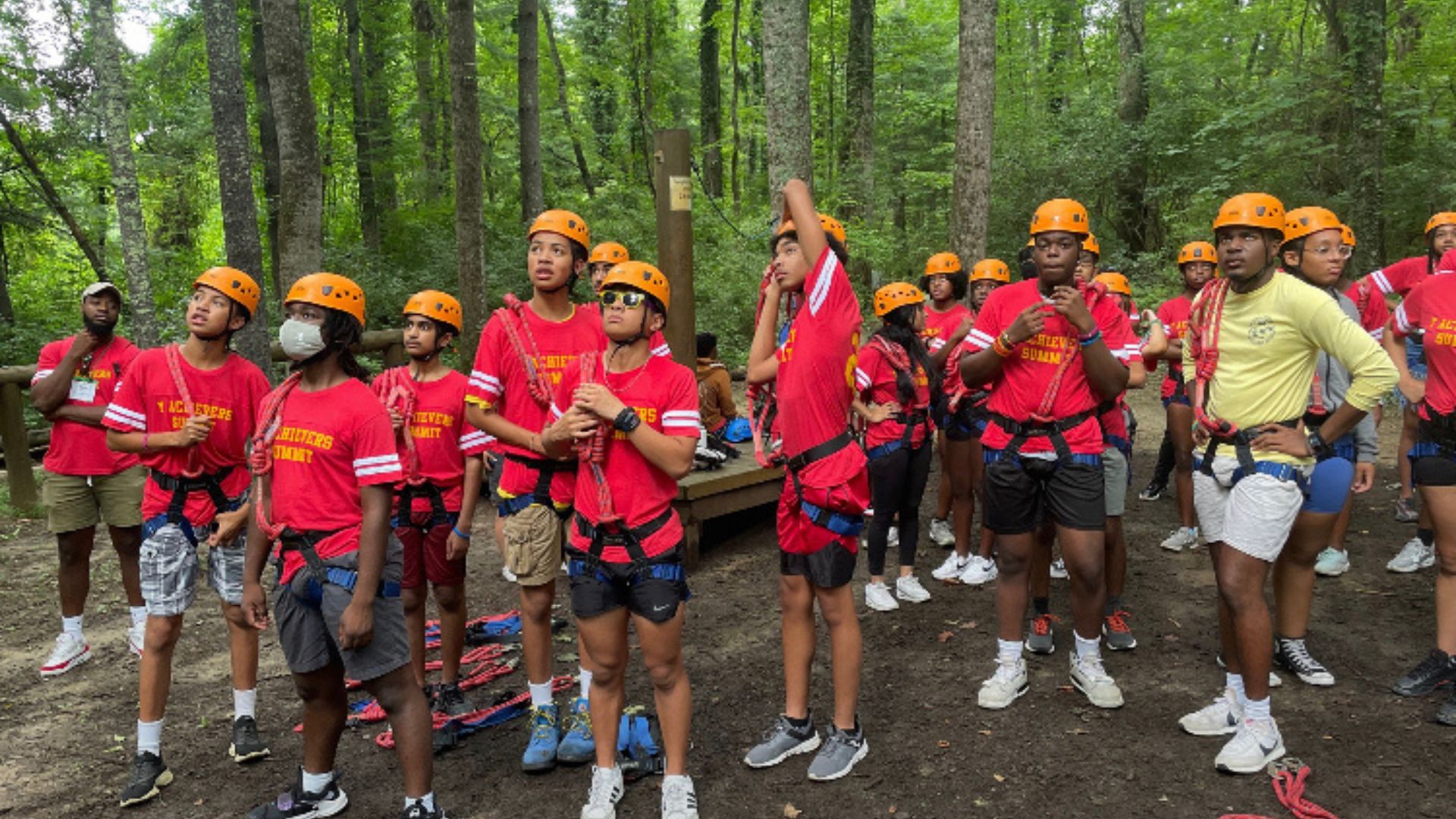 Black Achievers doing team building exercise outdoors at Leadership Summit