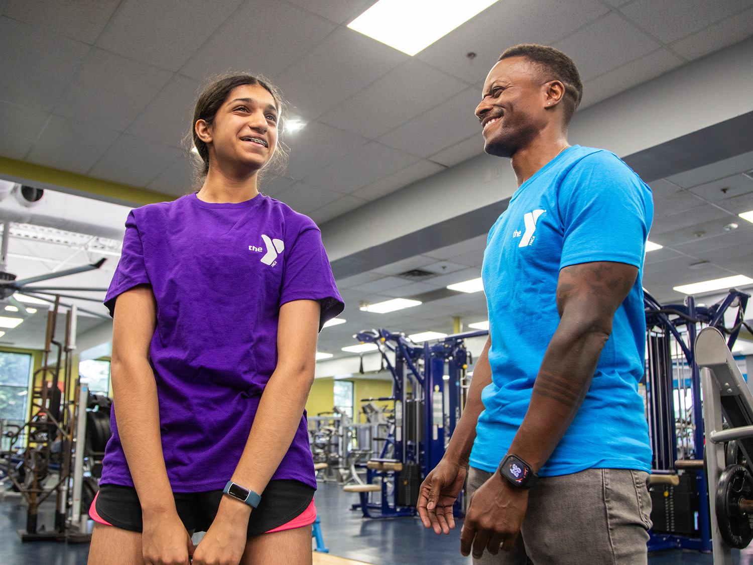 Personal trainer helping member Personal trainer helping member