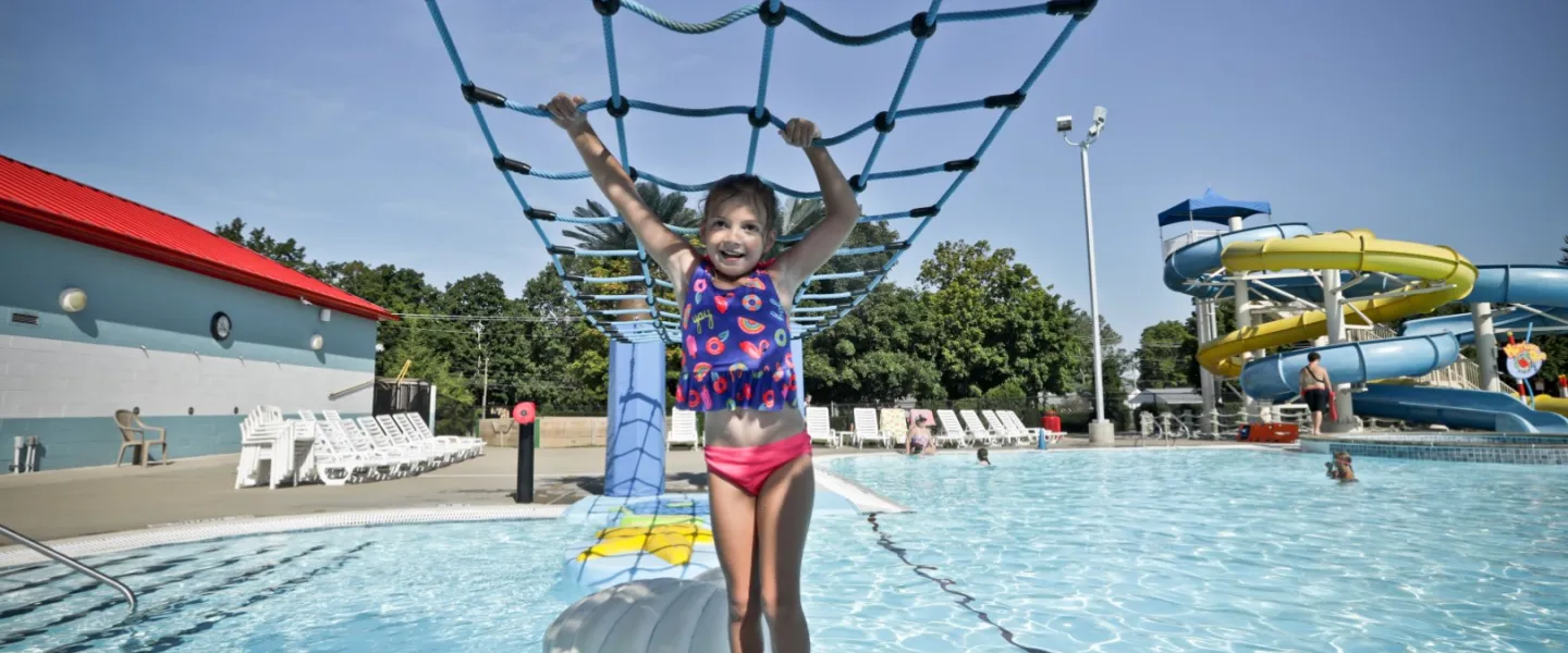 Child crossing pool with hanging net at Calypso Cove Waterpark