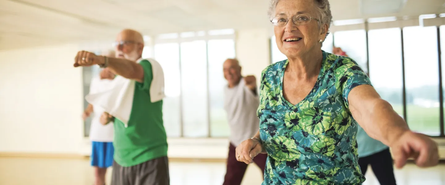 Older adults stretching at group dance class at YMCA Louisville