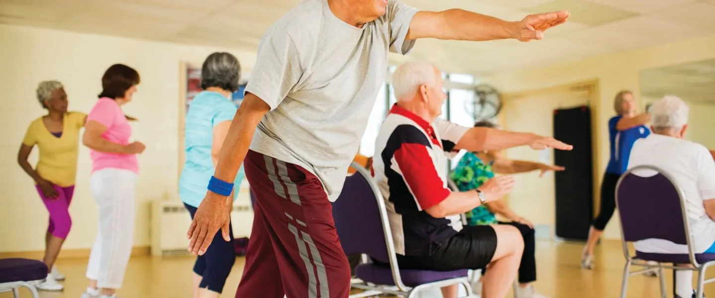 Older man stretching at mind and body class at YMCA Louisville