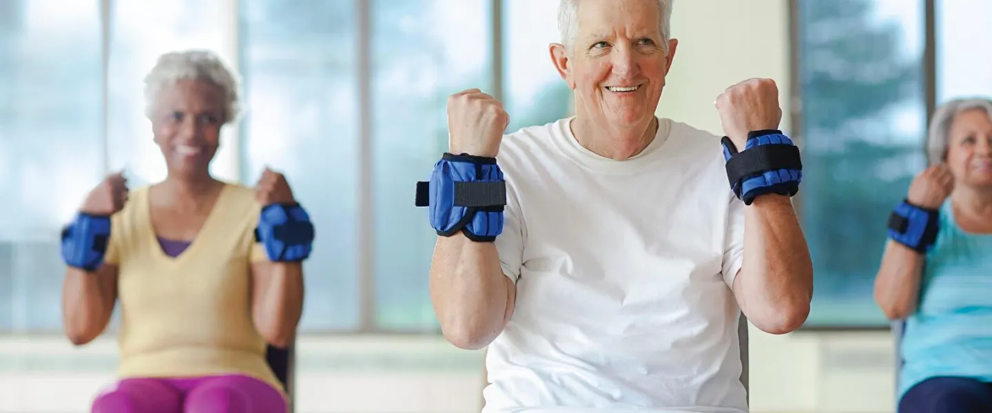 Older adults lifting weighted wrist bands at YMCA Louisville