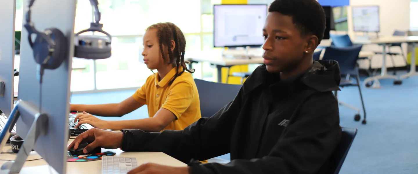 Teens looking at computer screens