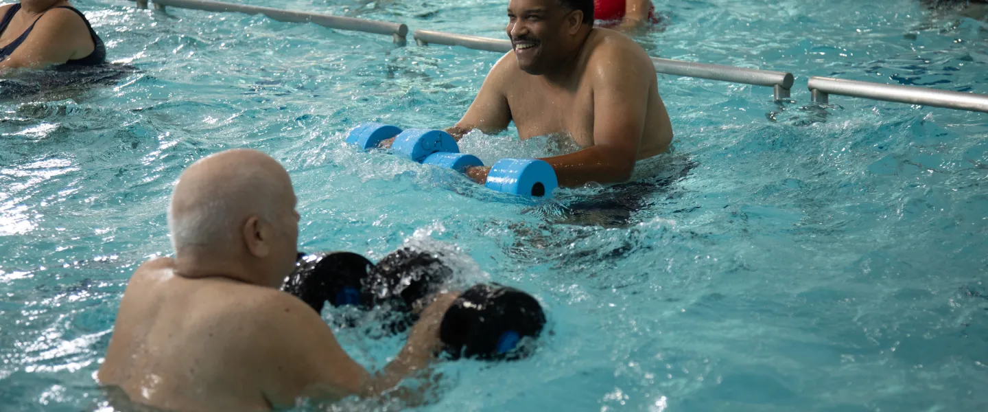 Group of people exercising at the pool