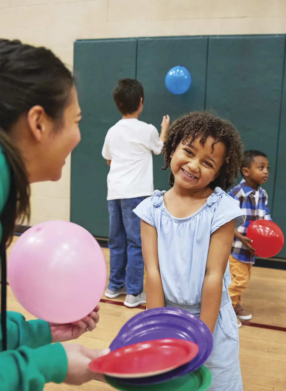 YMCA teen playing with little girl after school