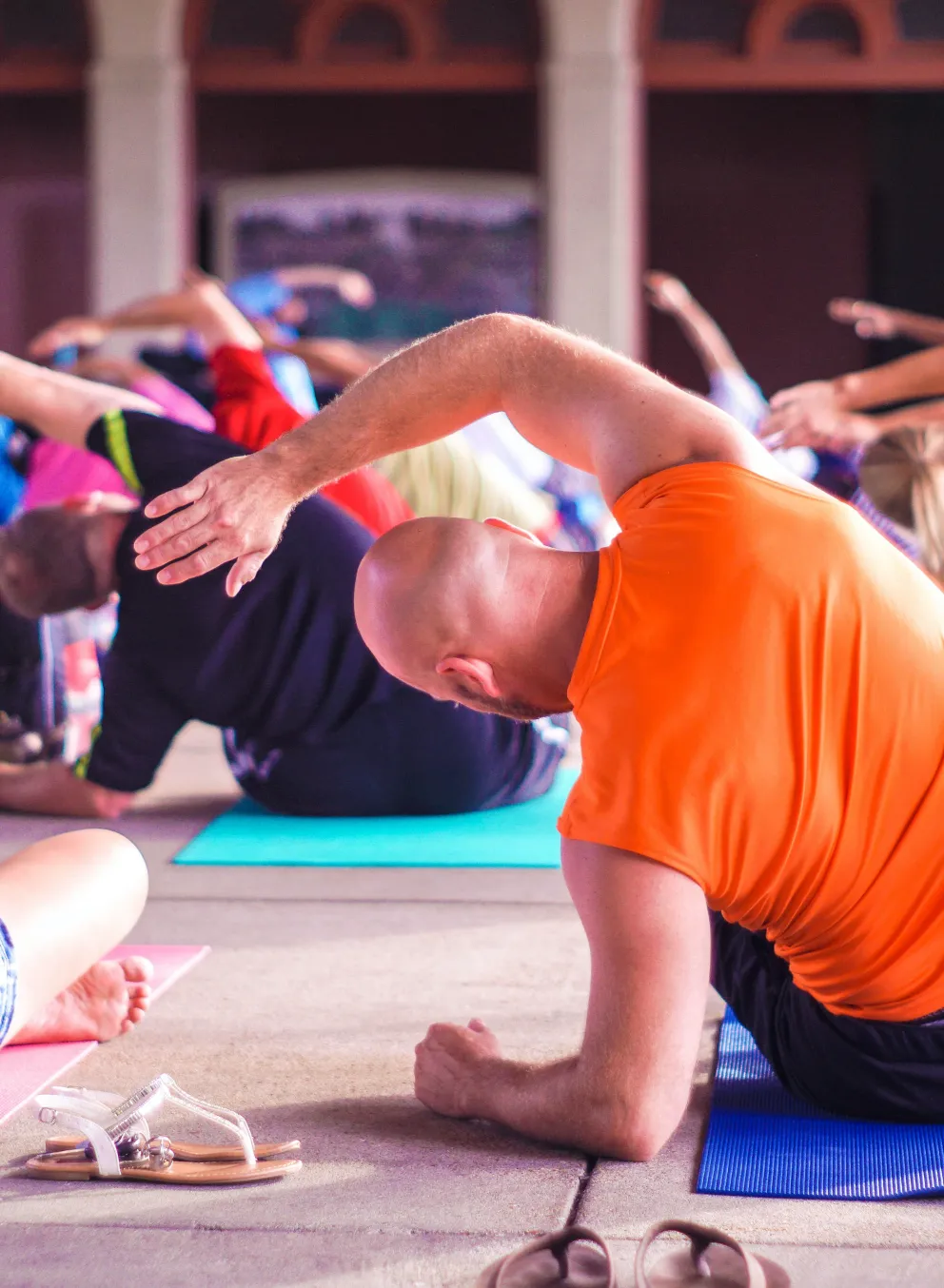 Group of adults doing side stretches at mind and body class