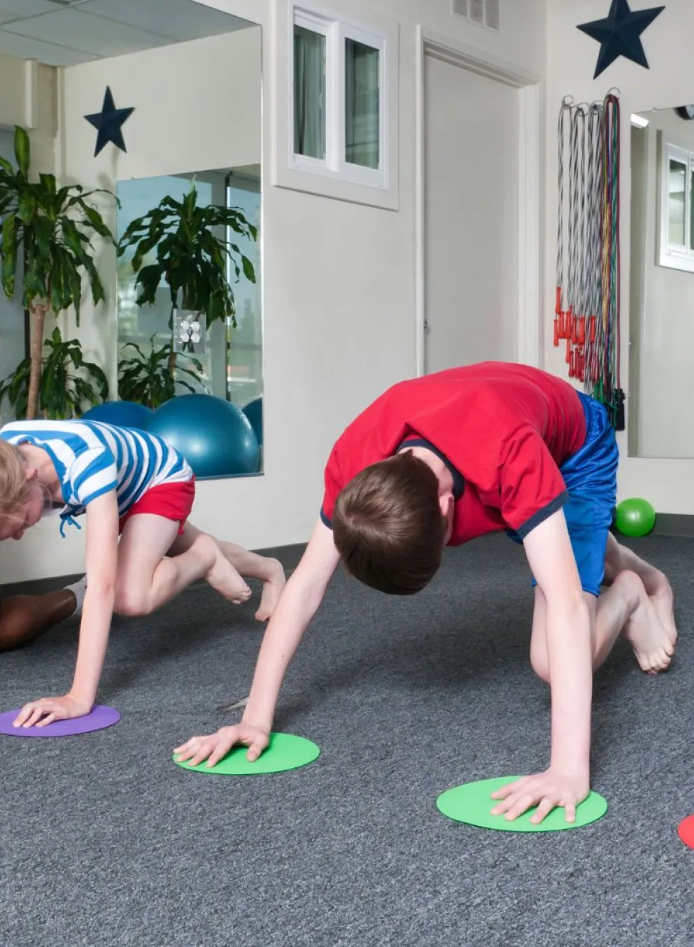 Group of kids working with a trainer training for YMCA youth sports