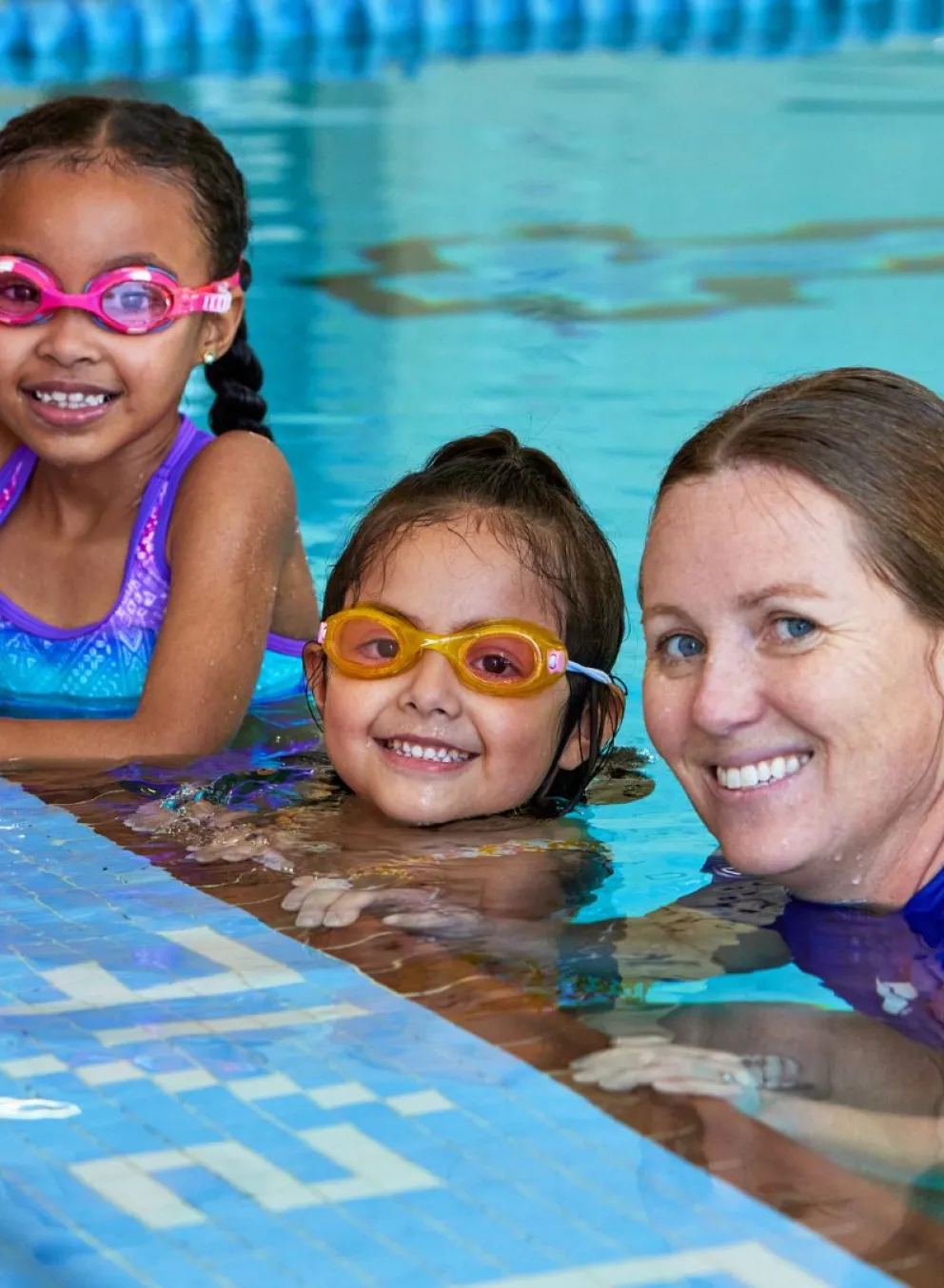 Kids with a YMCA swim instructor in the pool