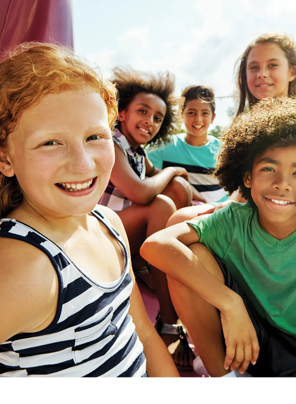 Group of kids sitting outside