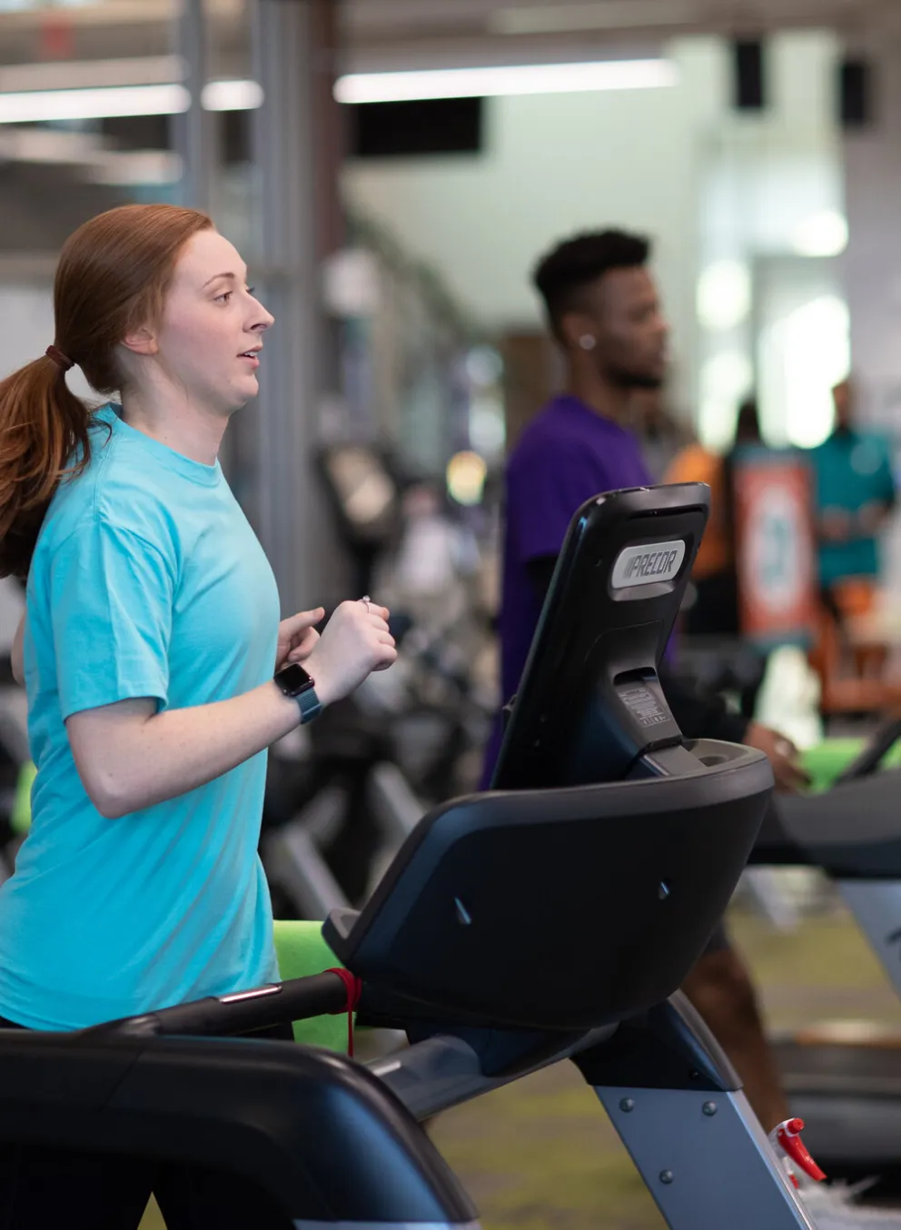 Two people running on treadmills