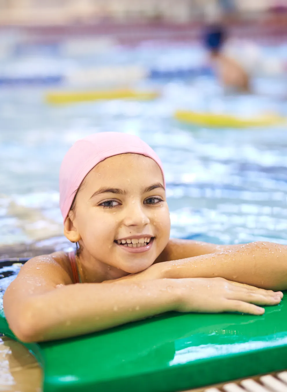 Girl on the side of a swimming pool
