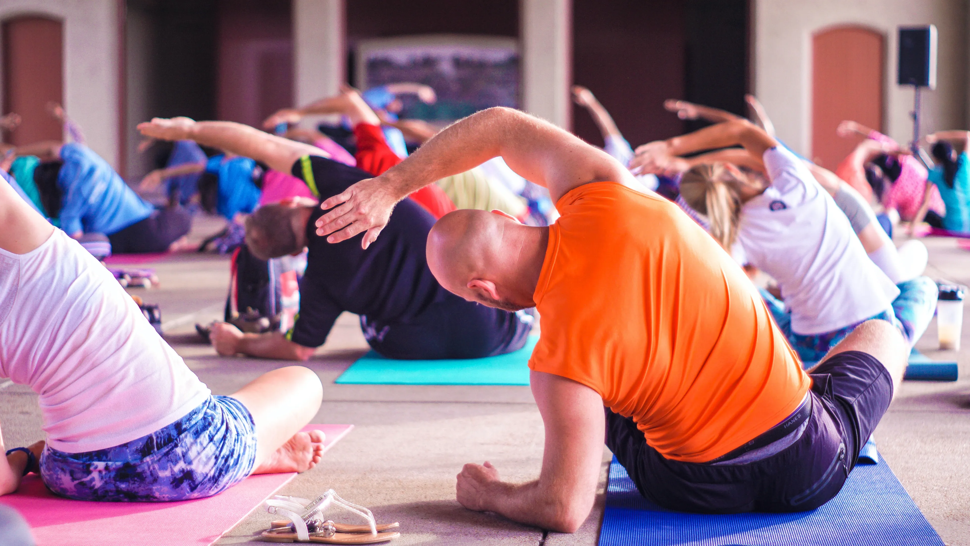 Group of adults doing side stretches at mind and body class