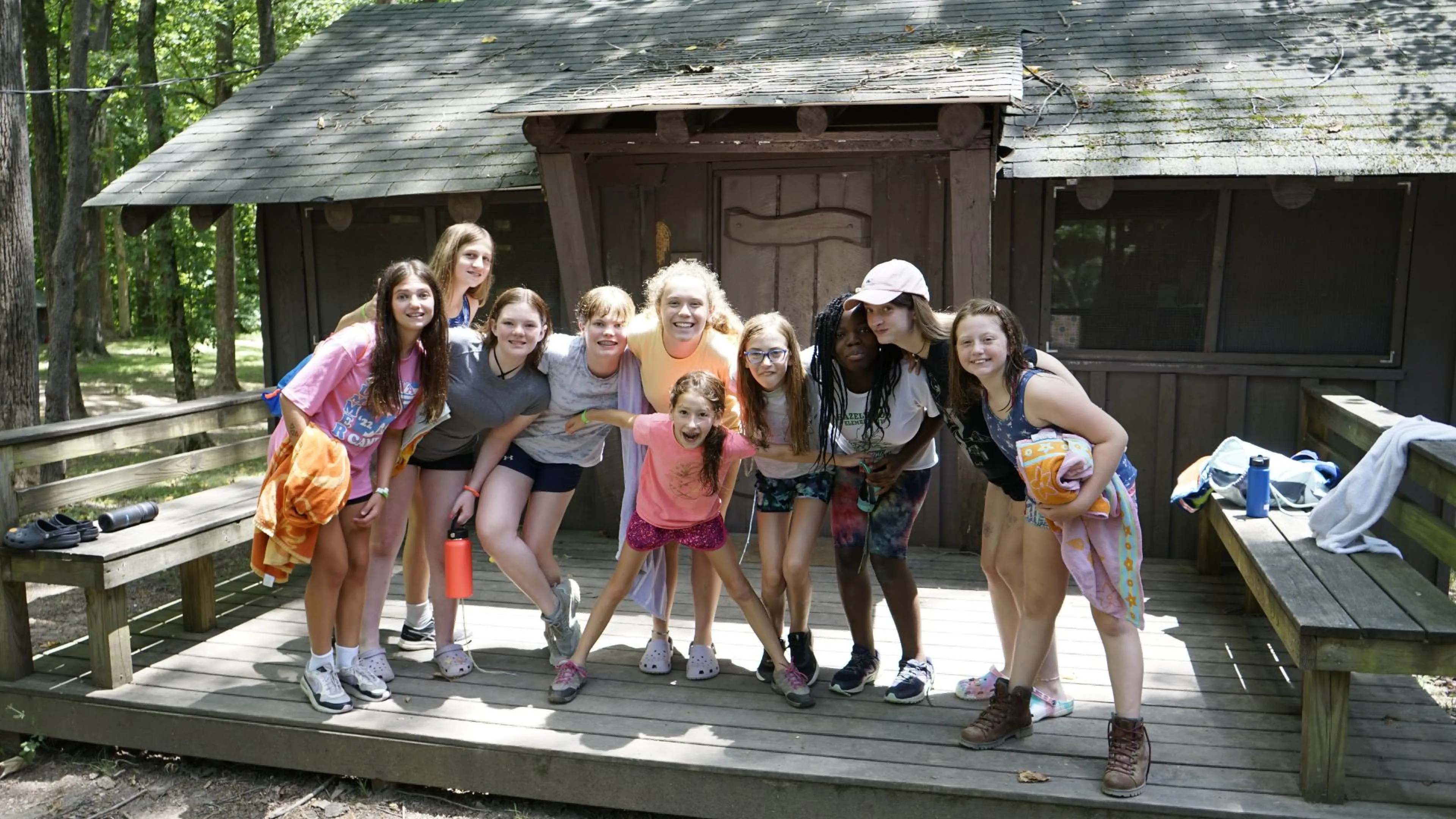 Group of campers standing together outside of their cabin at YMCA Camp Piomingo