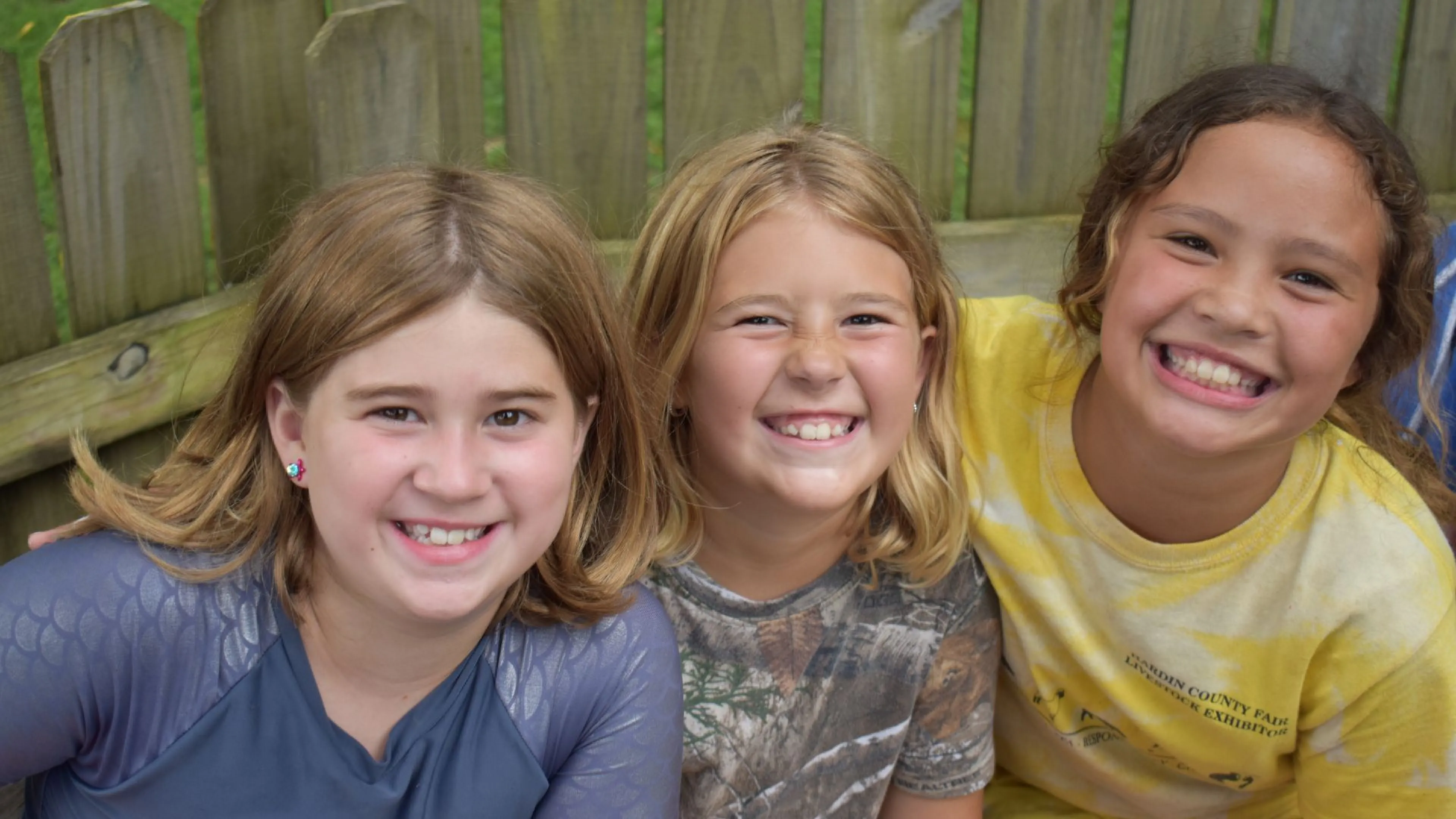 Group of campers sitting together smiling