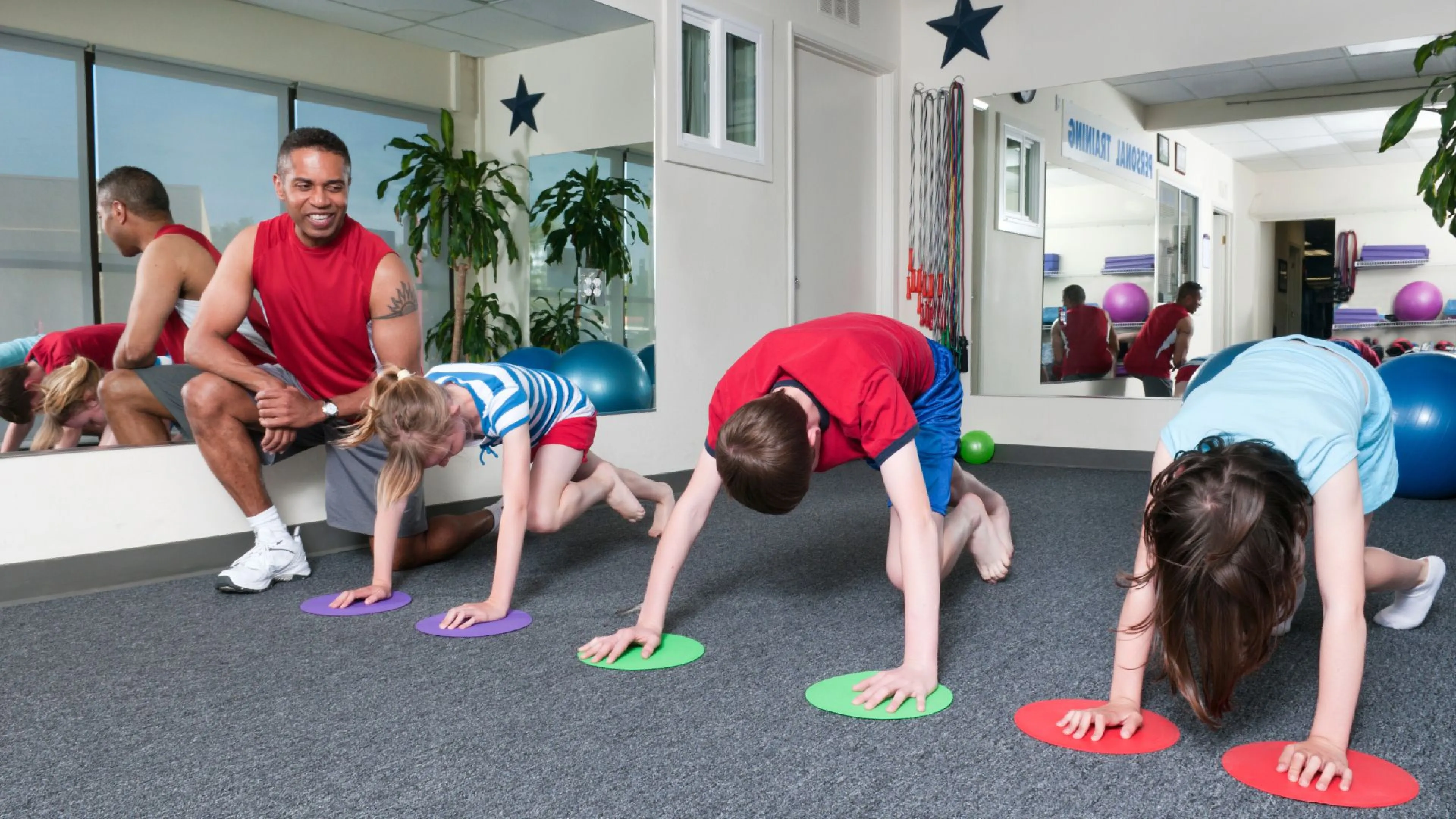 Group of kids working with a trainer training for YMCA youth sports