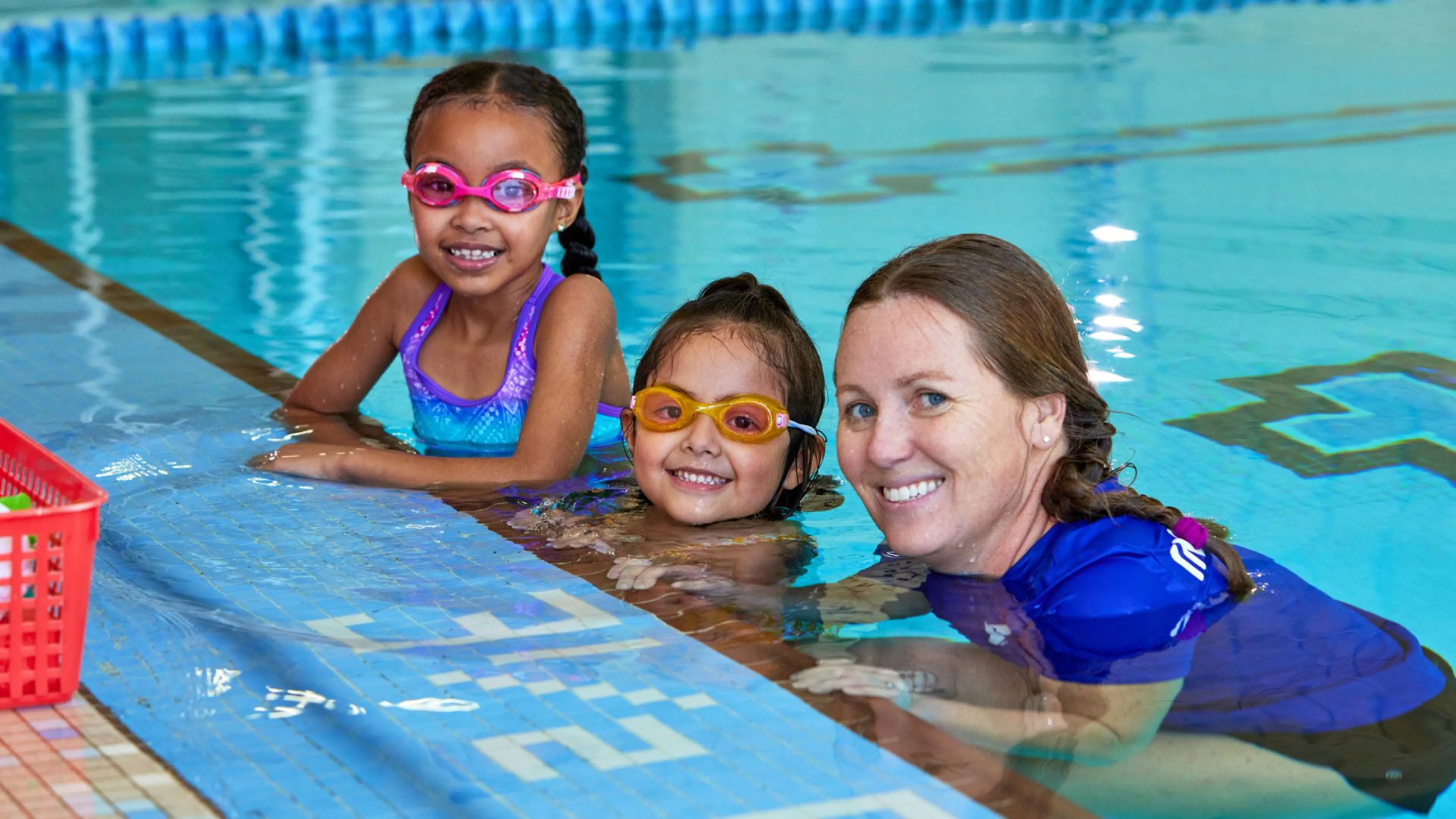 Kids with a YMCA swim instructor in the pool