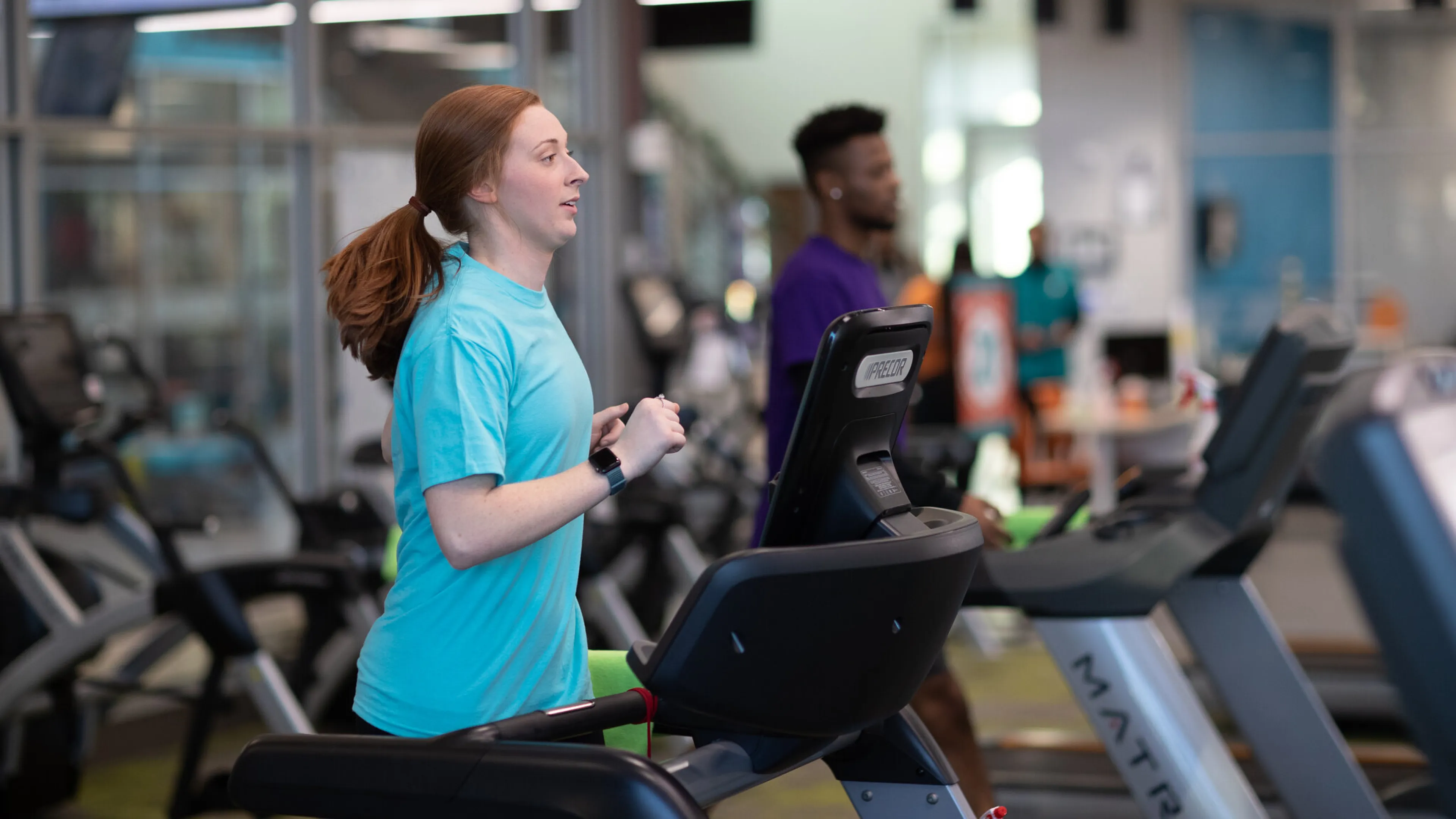 Two people running on treadmills
