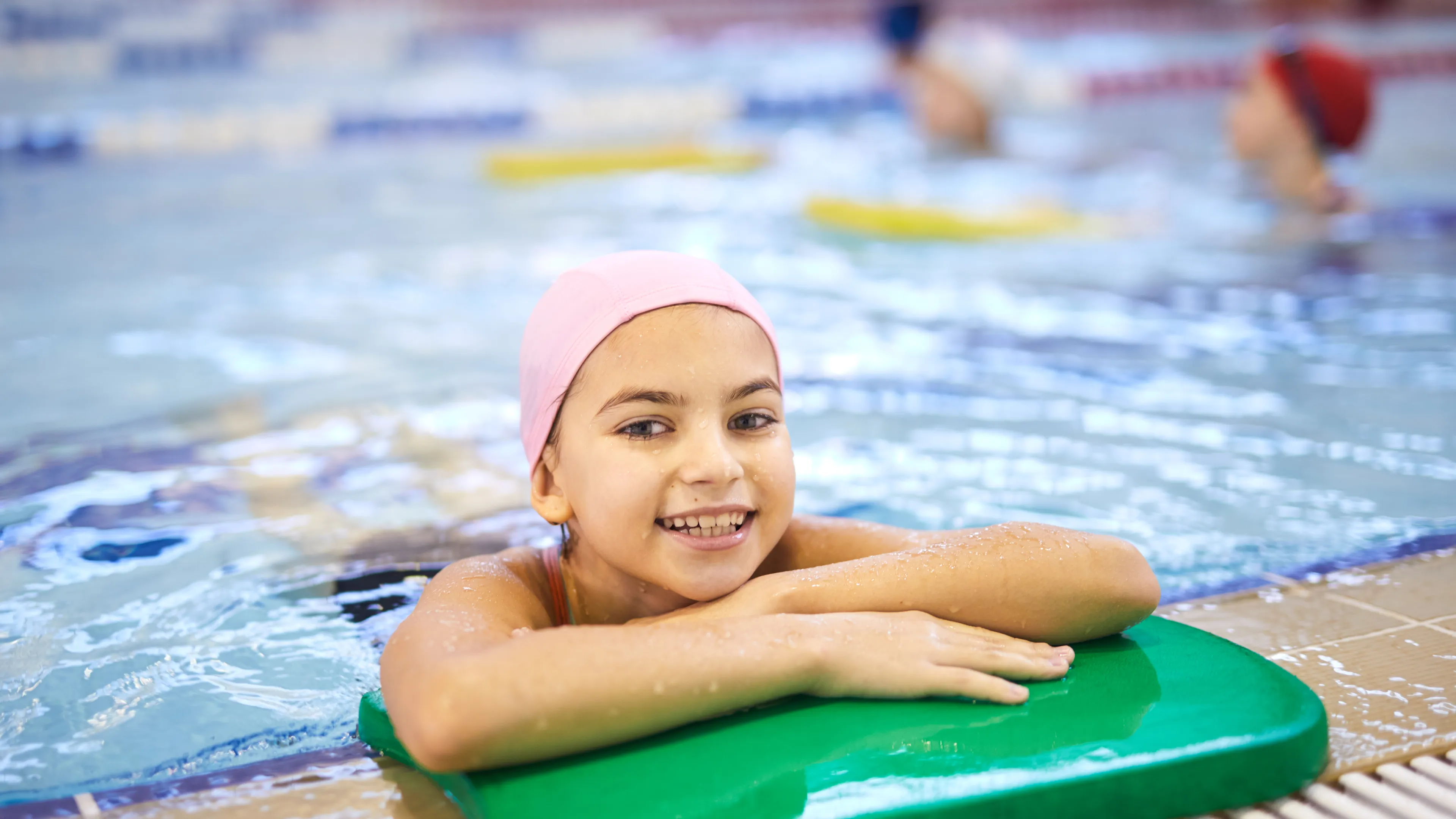 Girl on the side of a swimming pool