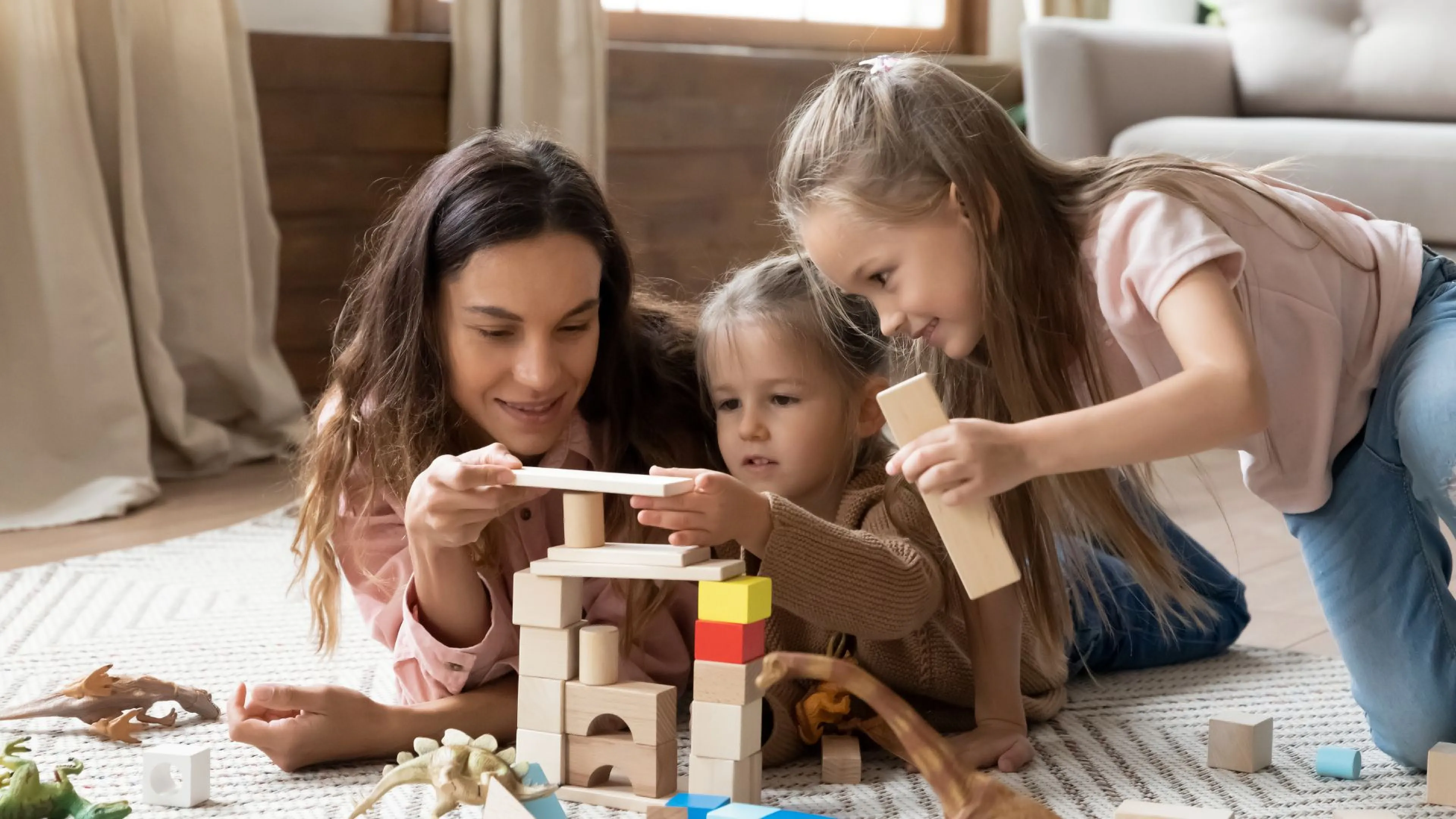 Babysitter playing blocks with kids
