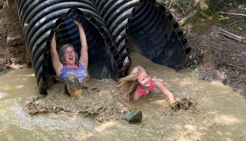 Kids going down a slide in the YMCA Mud Run